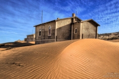 Kolmanskop houses in the desert with blue sky